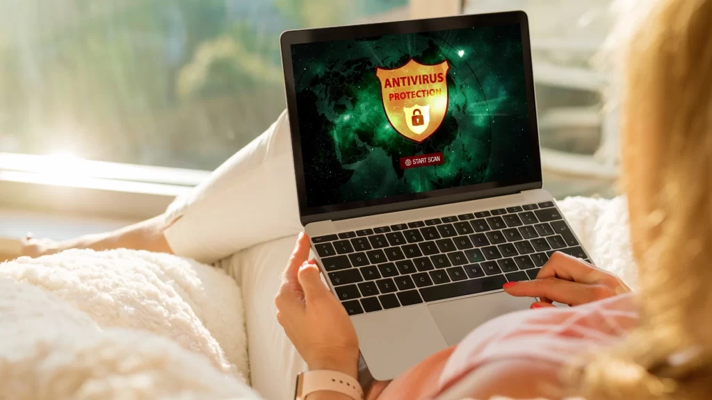 a girl using laptop in which antivirus is activated